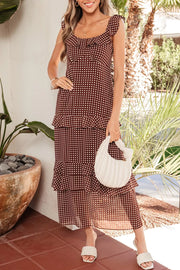Charming ruffled polka dot maxi dress in brown with white dots, tiered skirt, and tie straps.