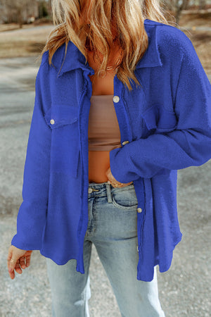 Royal blue textured shacket with raw-edge detailing and buttoned pockets.