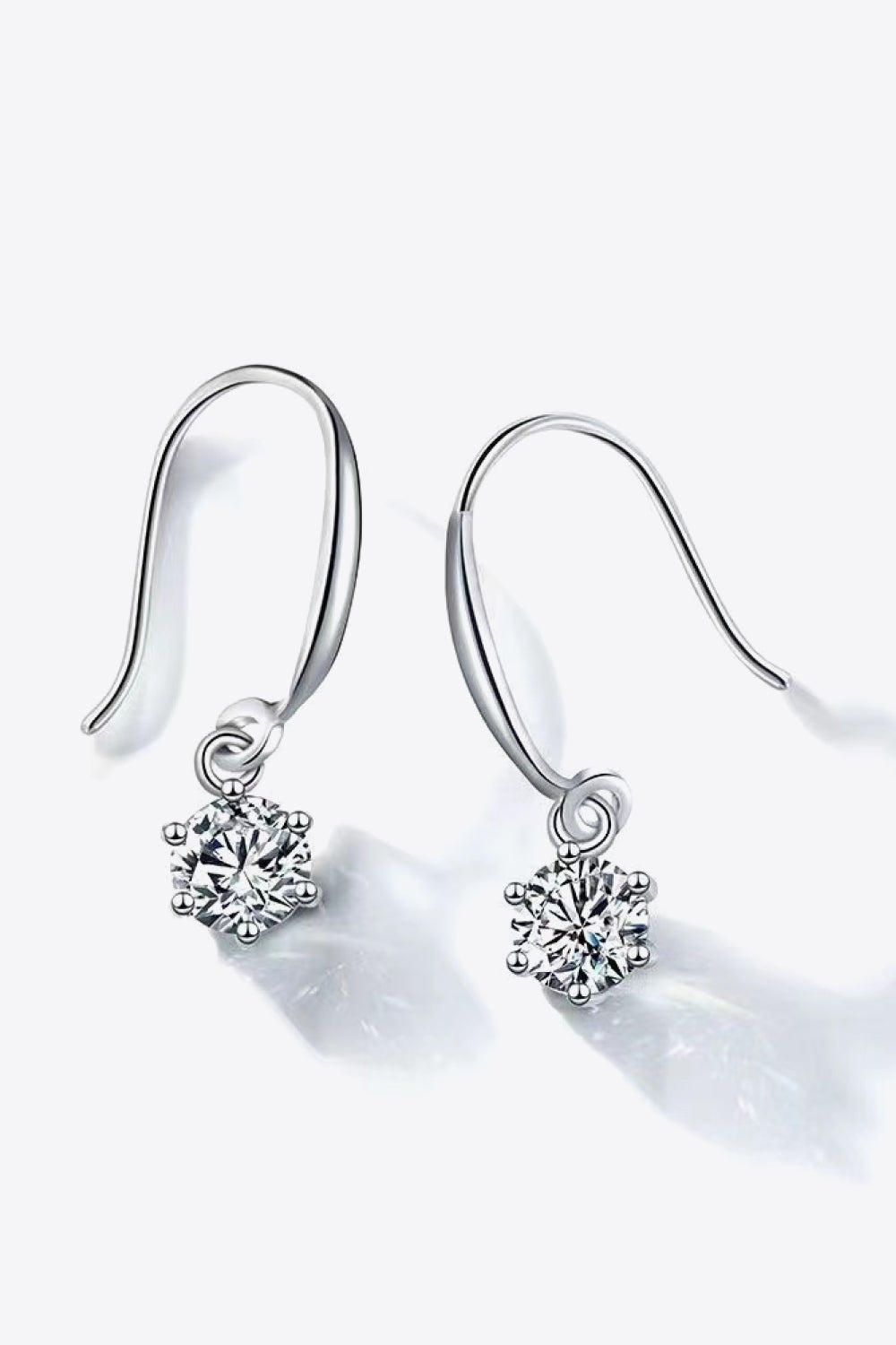 Silver drop earrings with cubic zirconia solitaire pendants.