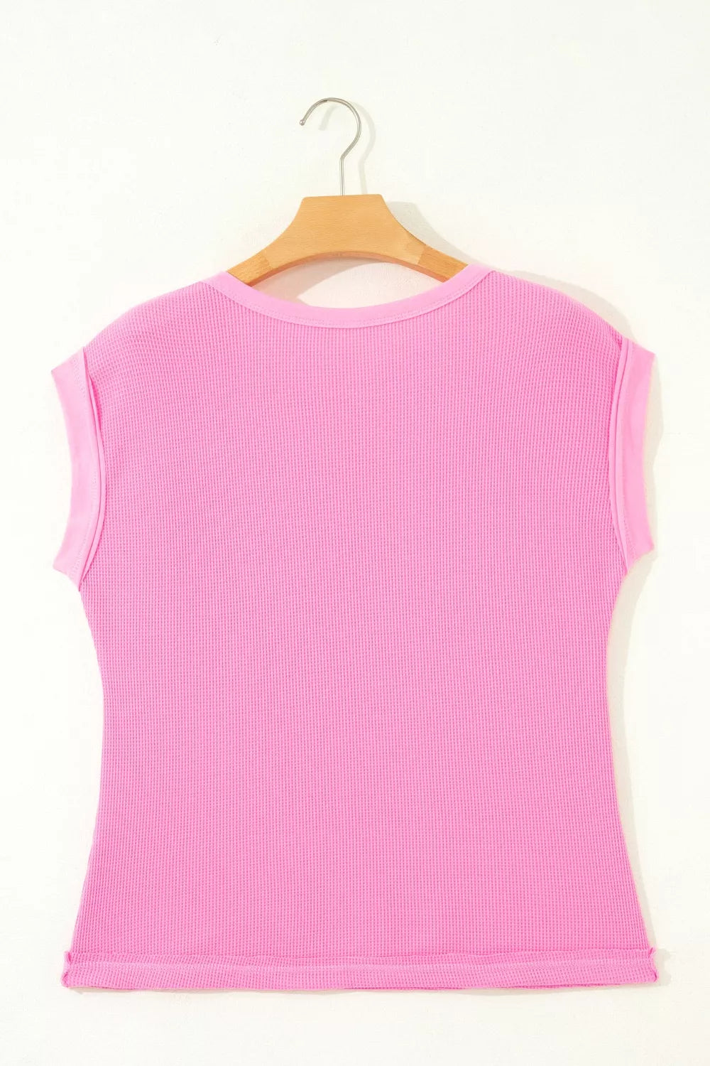 Pink waffled seam pocketed casual t-shirt with short sleeves and a crew neck.
