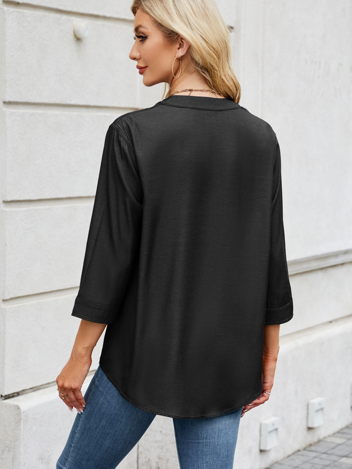 Black utility-pocket denim henley blouse with 3/4 sleeves and a curved hem.