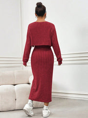 Orange-red ribbed knit midi dress with matching cropped cardigan and side slit.