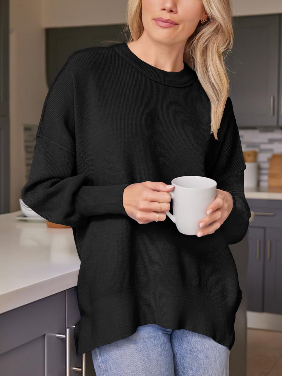 Black ribbed-knit relaxed fit sweater with crewneck and long sleeves.