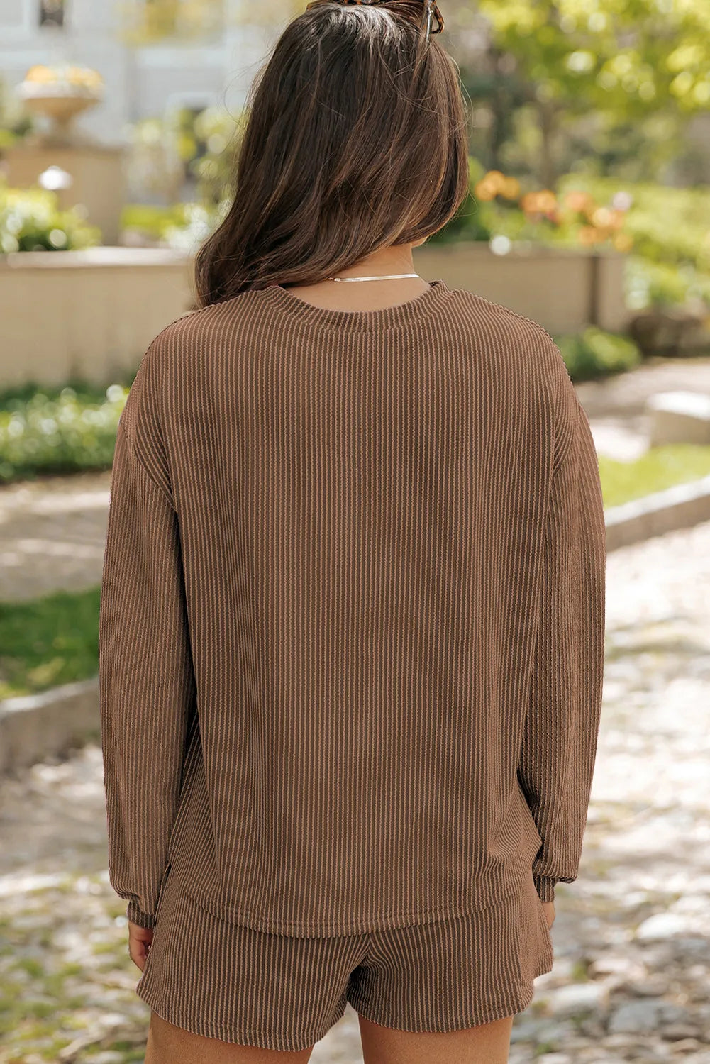 Brown ribbed knit matching set with long sleeves and shorts.