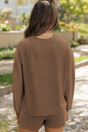 Brown ribbed knit matching set with long sleeves and shorts.