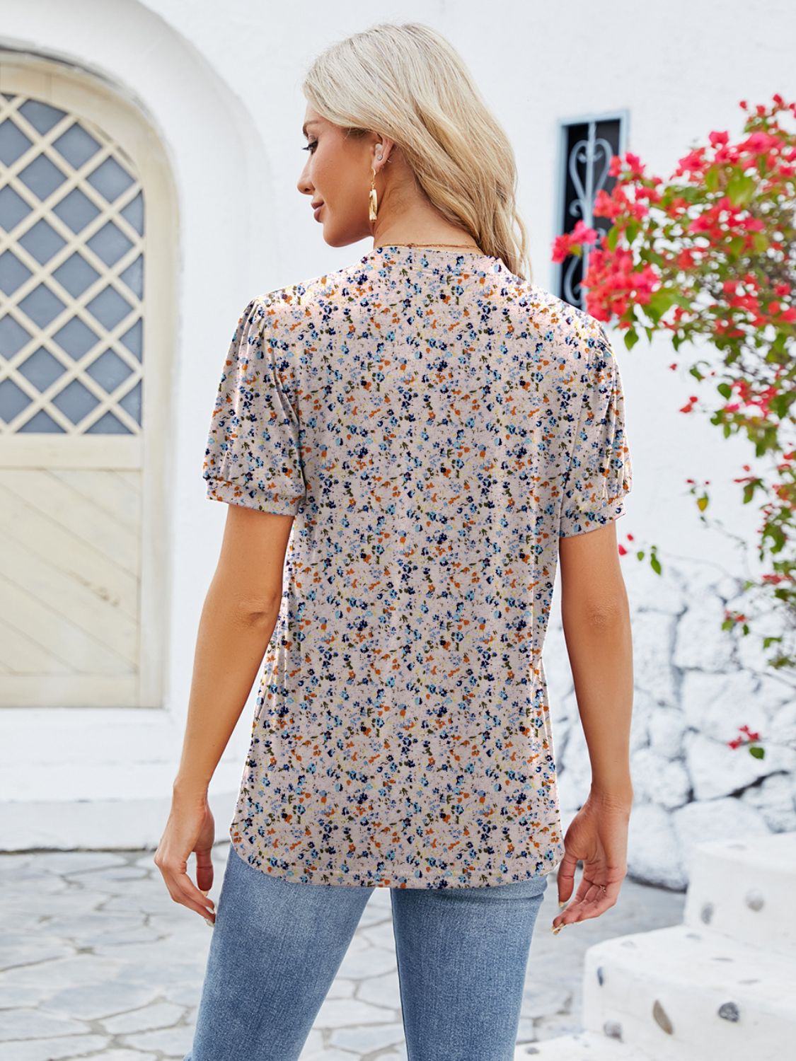 Floral print blouse with short sleeves and a keyhole neckline, in a multicolor floral pattern.