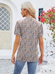 Floral print blouse with short sleeves and a keyhole neckline, in a multicolor floral pattern.
