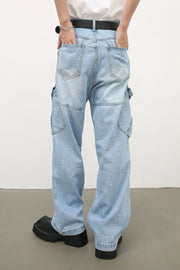 Baggy light wash denim cargo pants with utility pockets and a relaxed fit.