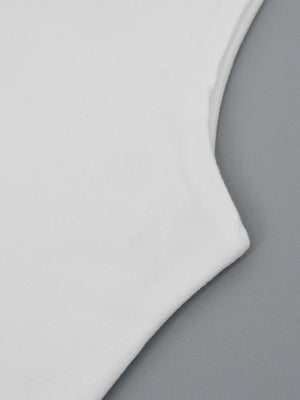 White flowy maxi dress detail showing soft fabric and wide strap seam.