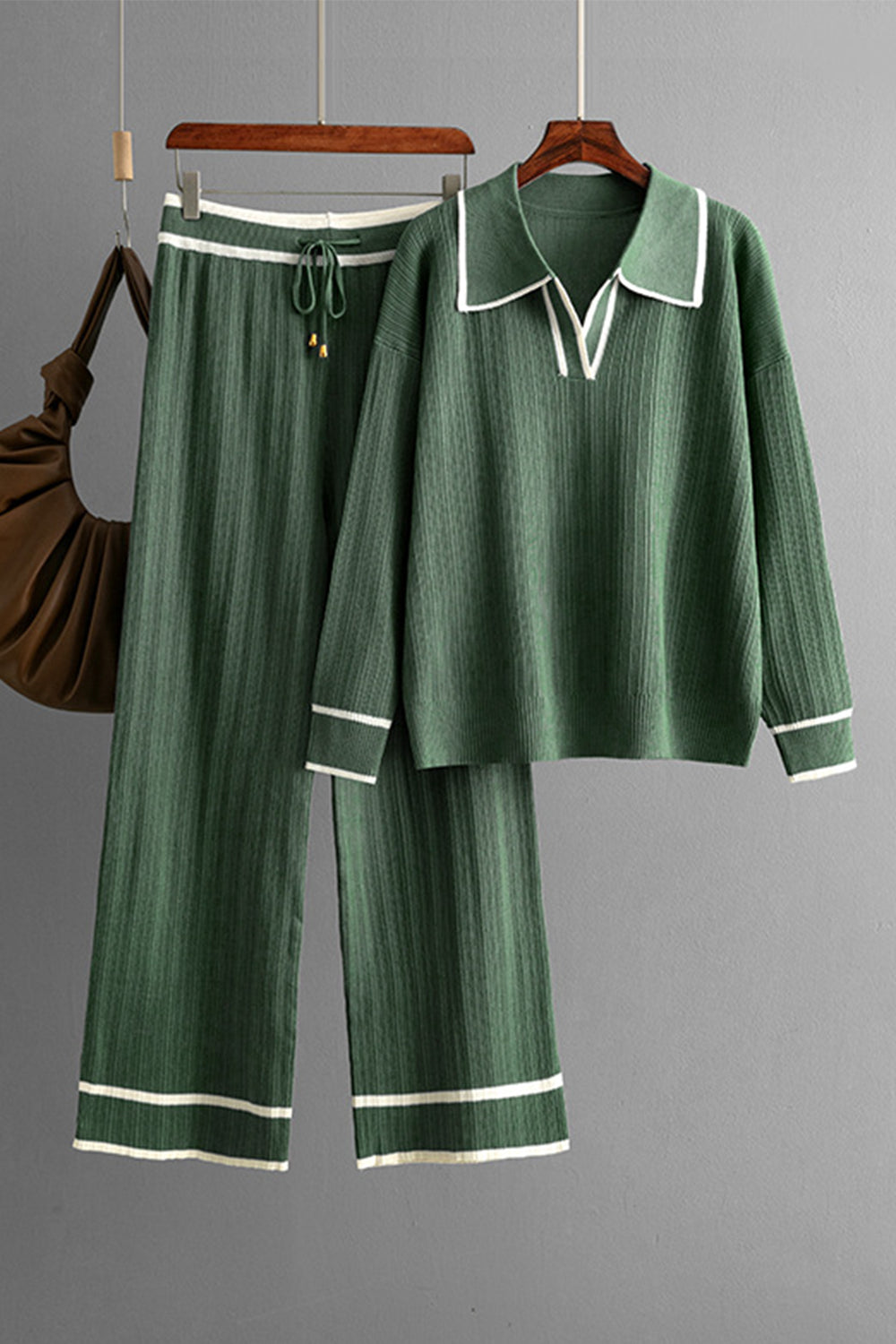 Dark green ribbed knit loungewear set with contrast trim, collared v-neck top and wide leg pants.