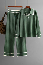 Dark green ribbed knit loungewear set with contrast trim, collared v-neck top and wide leg pants.