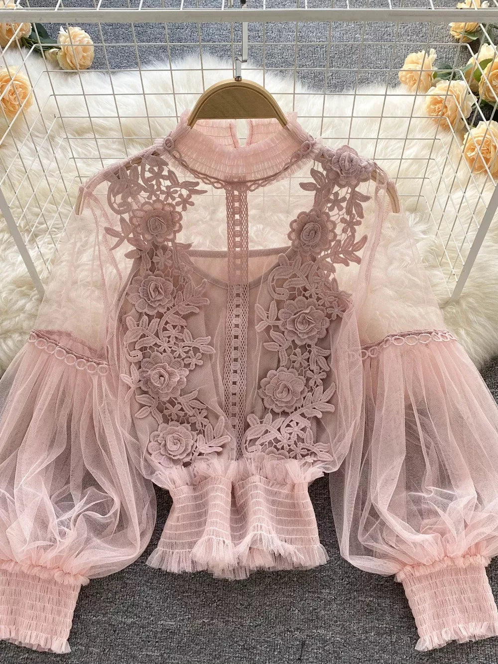 Light pink embroidered lace blouse with puff sleeves and ruffled hem, includes cami.
