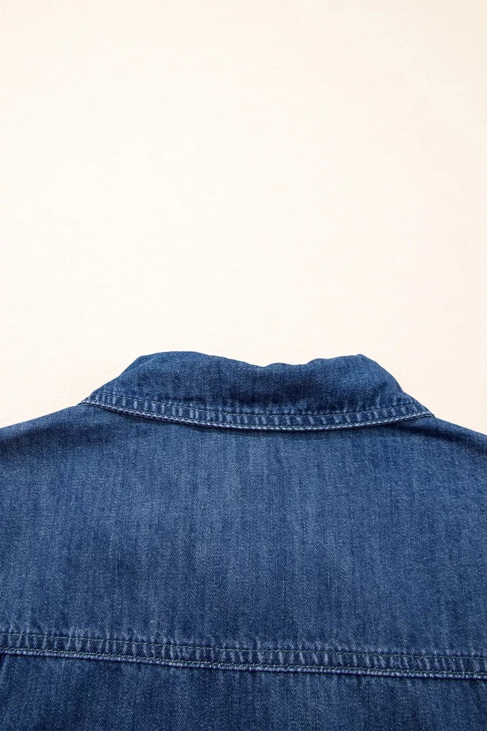 Blue denim collared mini shift dress with visible stitching detail.