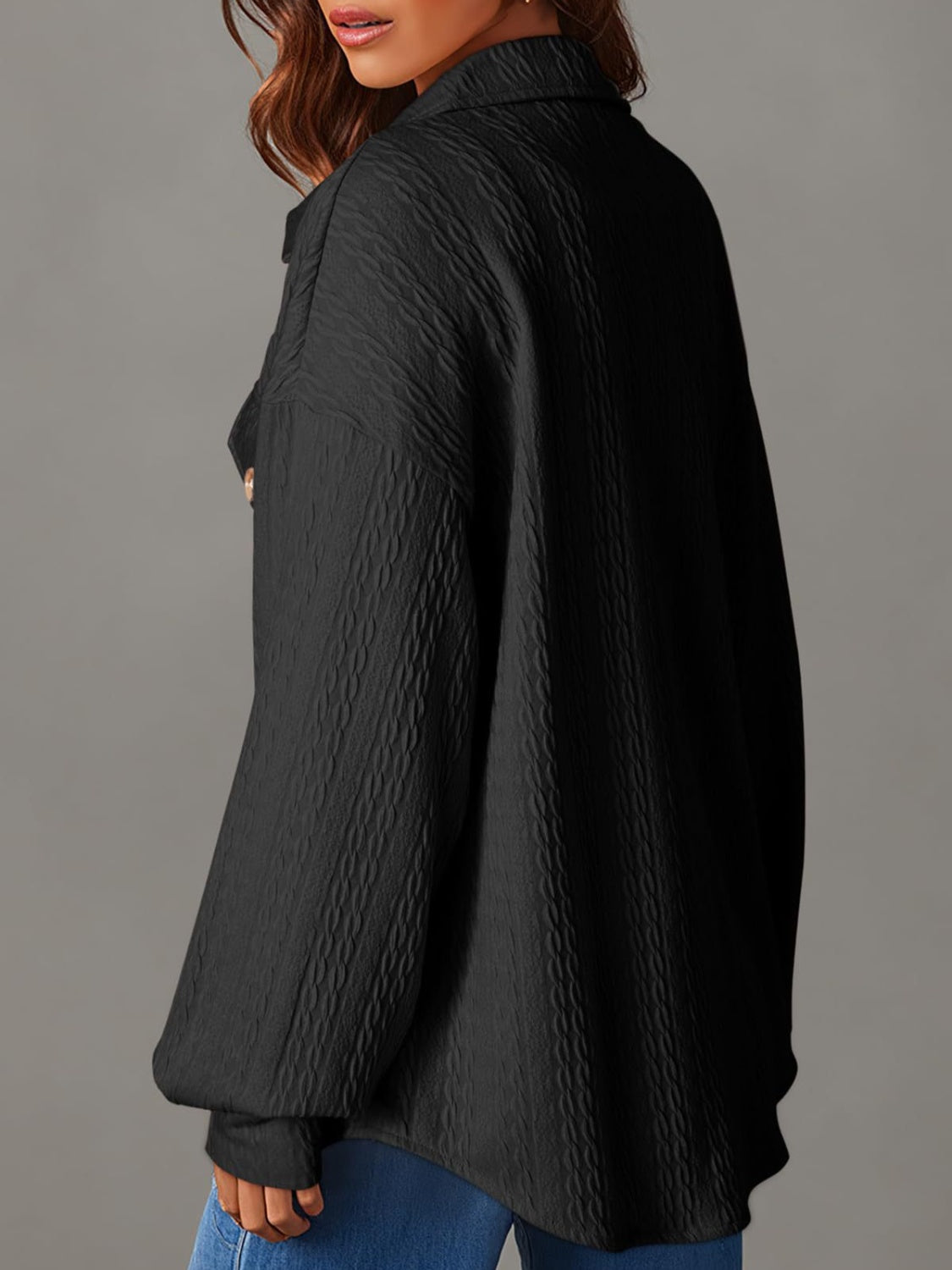 Black textured oversized button-down shacket with a collared neckline and long sleeves.