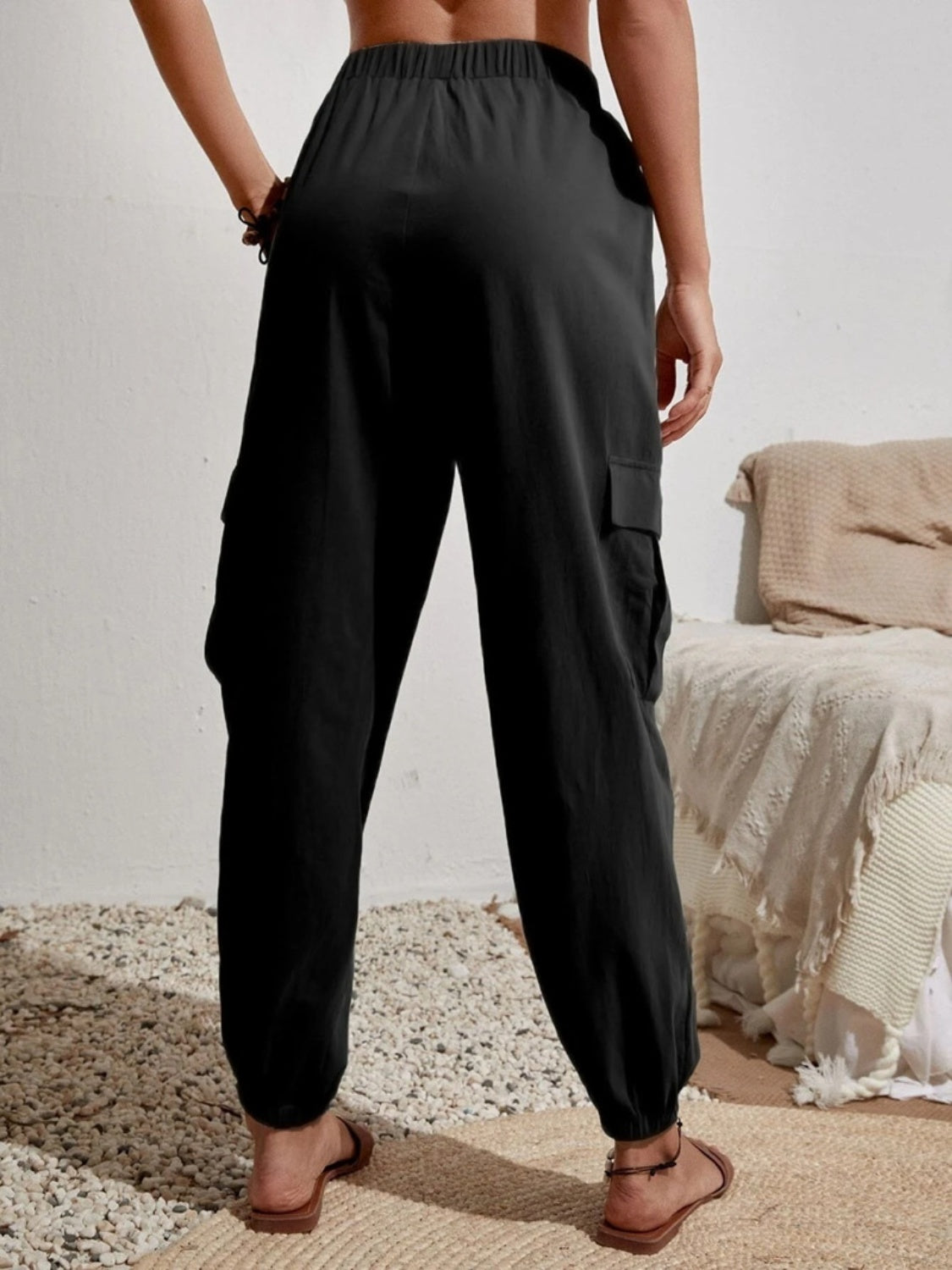 Black textured cargo lounge trousers with elastic waist and cuffed hem.