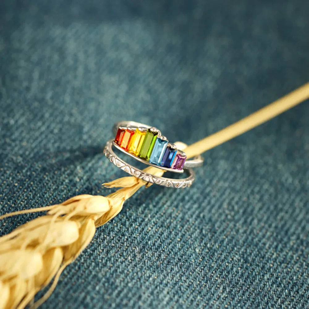 Sterling silver stacked ring set with rainbow baguette gems and textured band.
