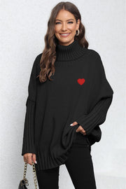Black knit turtleneck sweater with batwing sleeves and a red heart embroidery detail.