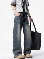 Men's light wash wide-leg denim jeans with distressed details and a vintage look.