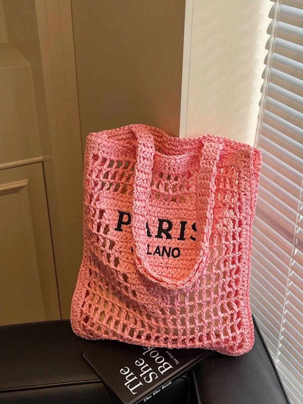 Pink crochet tote bag with "PARIS LANO" text detail.
