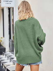 Oversized green knit V-neck sweater with slouchy fit and ribbed hem.