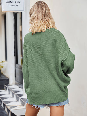 Oversized green knit V-neck sweater with slouchy fit and ribbed hem.