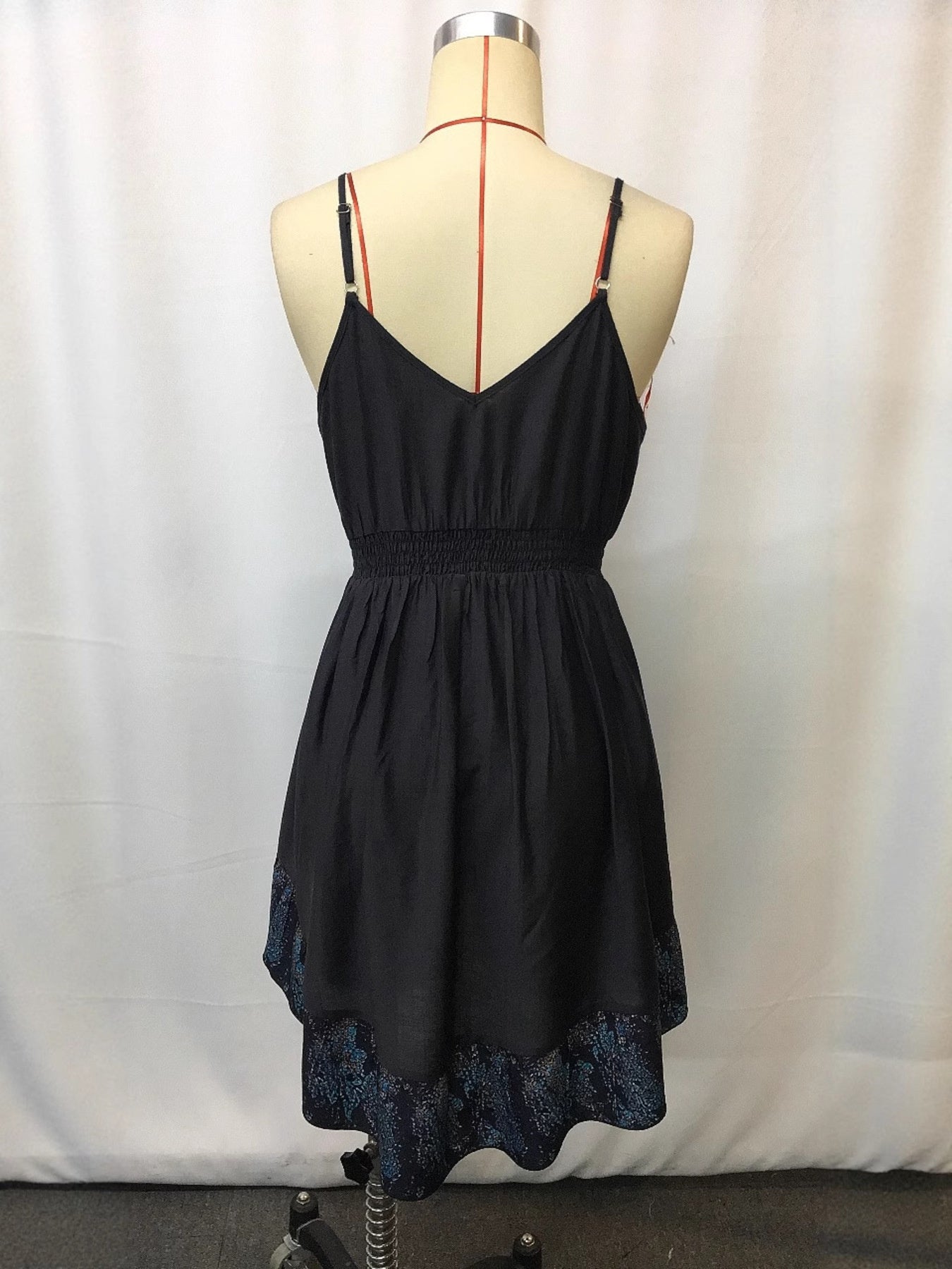 Black cami mini dress with smocked waist and floral print hem