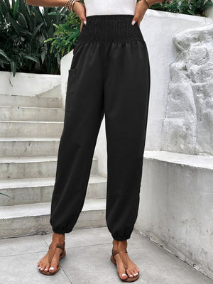 Black relaxed-fit cargo pants with smocked waist and elastic cuffs.