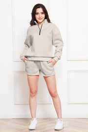 Ivory quarter-zip loungewear set with shorts and a mock neck sweatshirt.