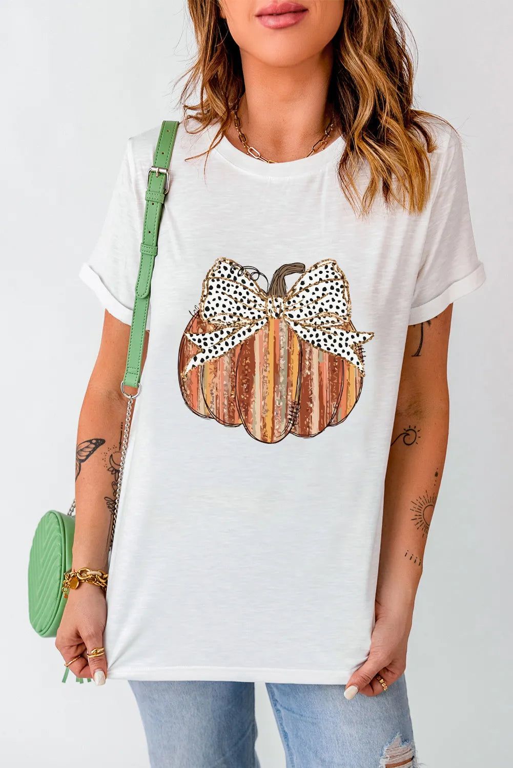 White t-shirt with striped pumpkin graphic and leopard print bow detail