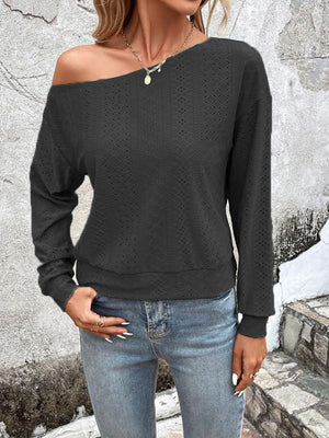 Black off-shoulder eyelet knit blouse with long sleeves and a relaxed fit.