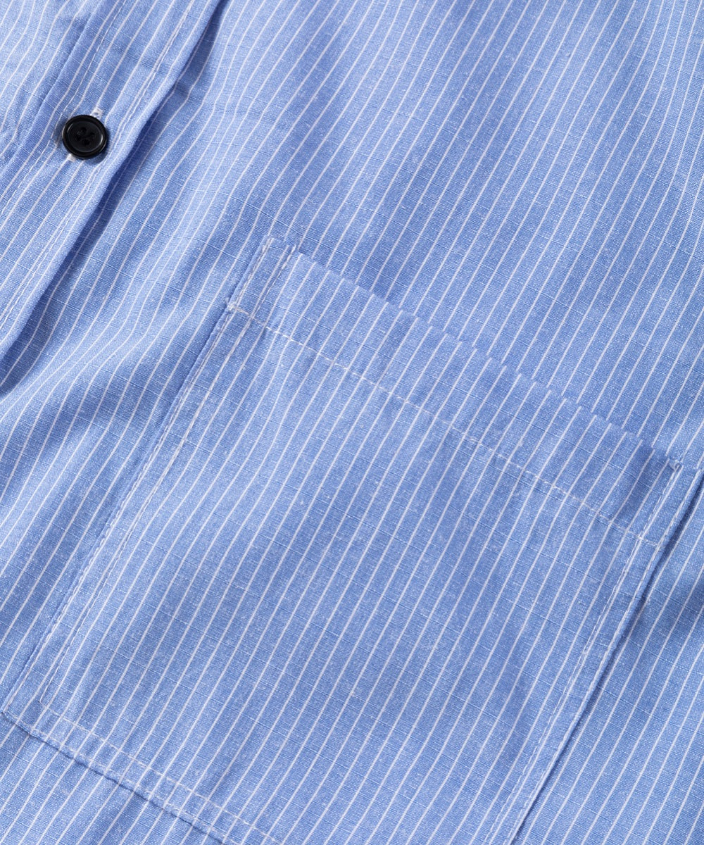 Light blue button-down shirt with white pinstripes and a chest pocket.