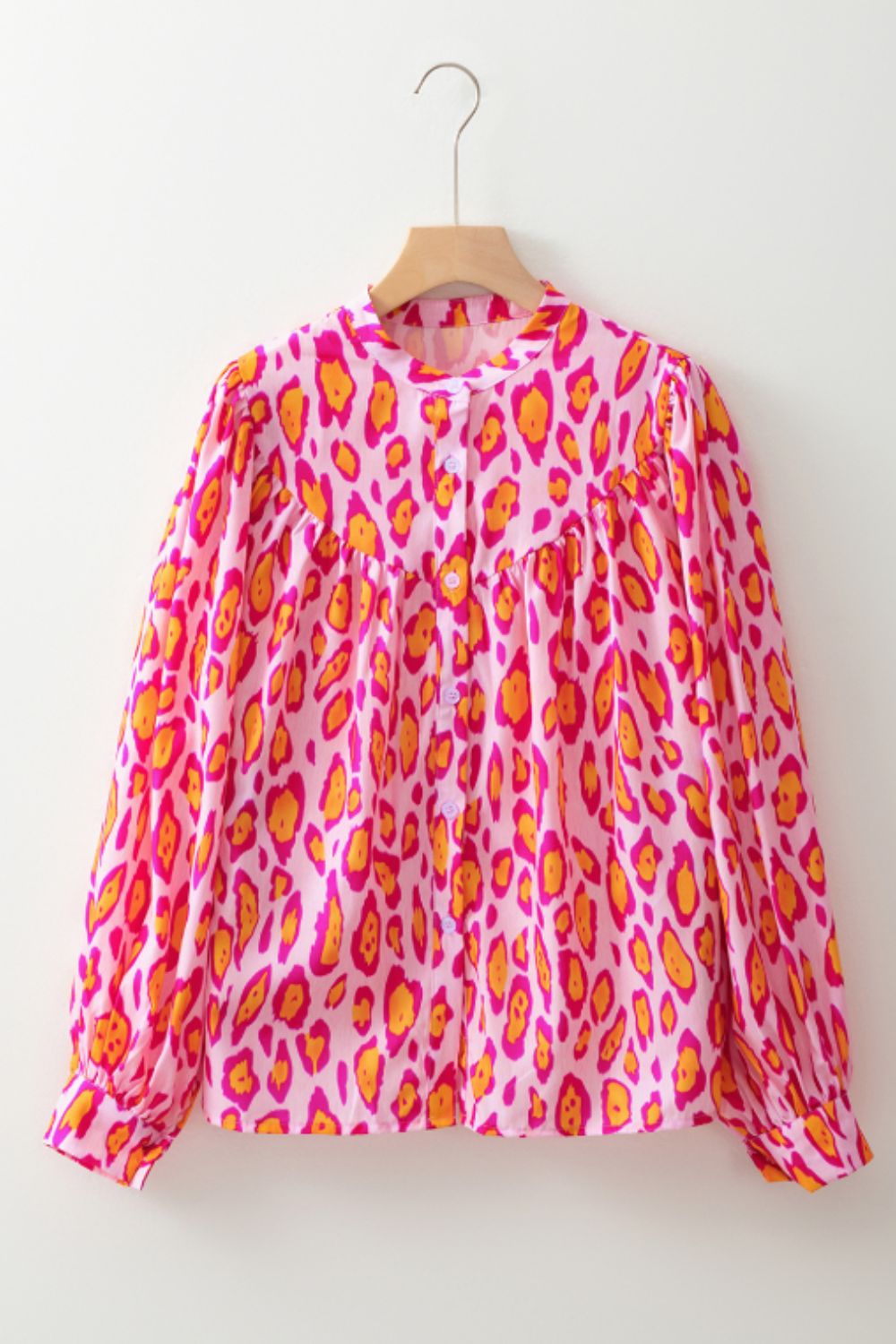 Pink leopard print blouse with balloon sleeves and button front.
