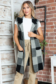 Geometric knit duster vest in black and tan checkered pattern with pockets.