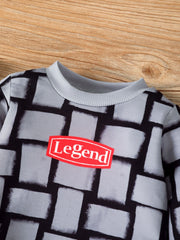 Children's grey long sleeve top with block pattern and red "Legend" graphic.