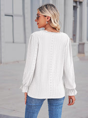 White eyelet blouse with lace trim and ruffle cuffs.