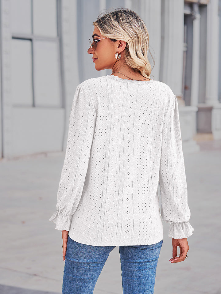 White eyelet blouse with lace trim and ruffle cuffs.