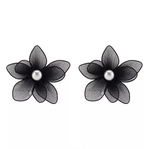 Black floral stud earrings with pearl centers, made of sheer fabric.