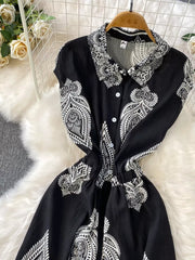 Black wide leg romper with white paisley print, collared, button-down, short sleeves