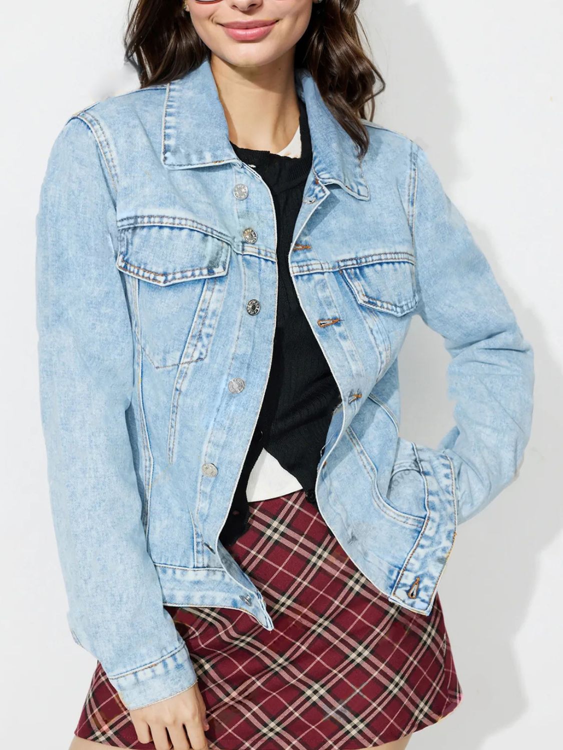 Light wash denim jacket with classic buttoned front and chest pockets.