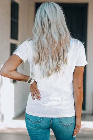 White graphic t-shirt with short sleeves and a casual fit, styled with jeans.