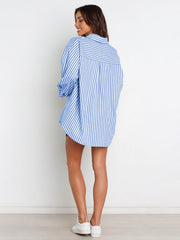 Oversized light blue and white striped shirting with button front, worn with shorts.