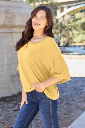 Yellow boxy dolman crop t-shirt with relaxed fit and short sleeves.