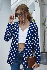 Dark blue polka dot open-front blazer with a white crop top and jeans.