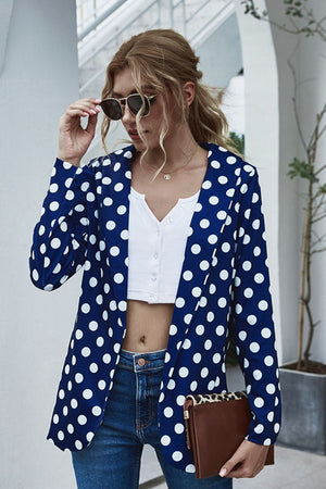 Dark blue polka dot open-front blazer with a white crop top and jeans.