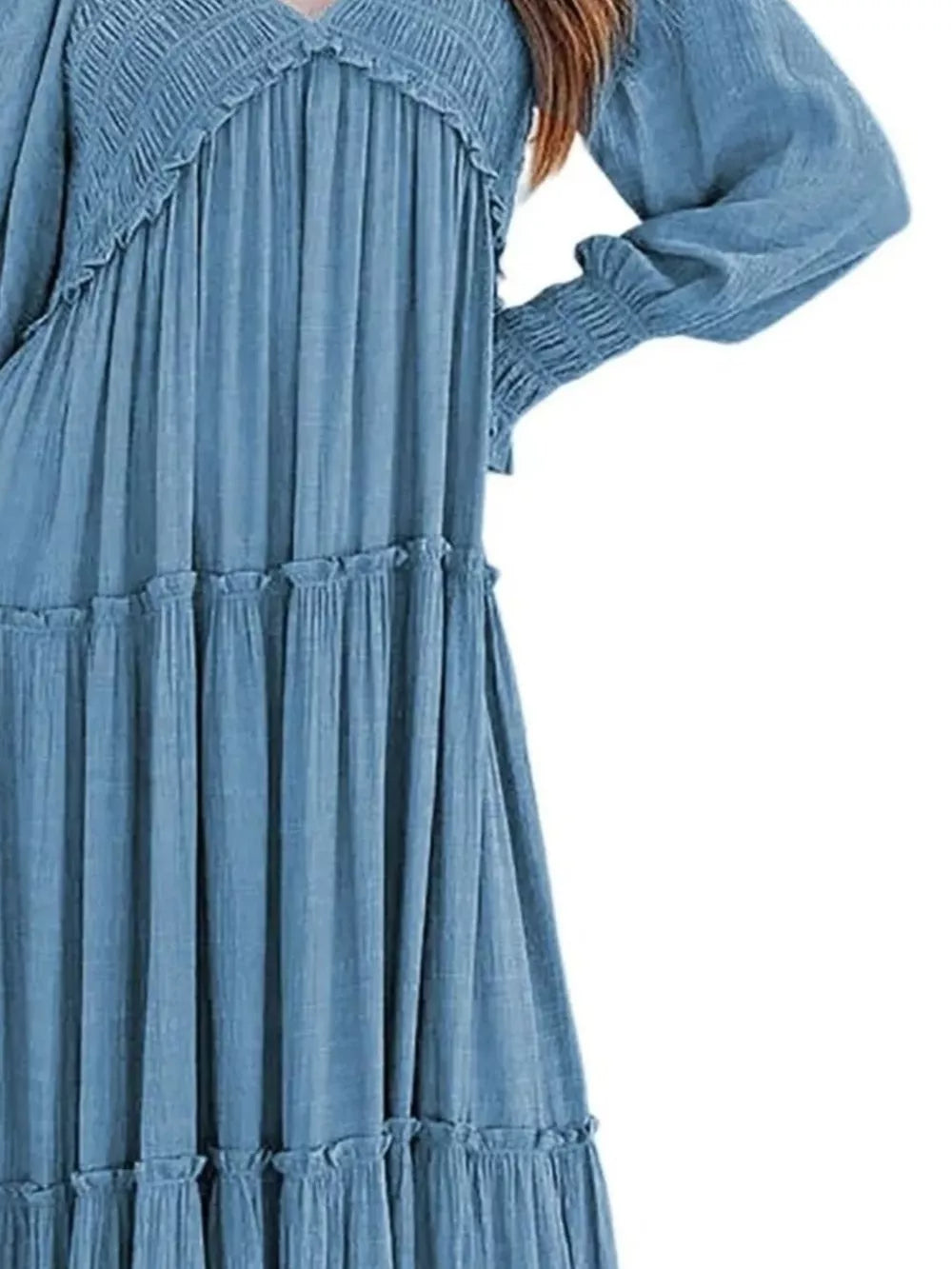Blue smocked V-neck tiered maxi dress with long sleeves and ruffled hem detail.