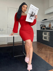 Red ruched bodycon dress with sheer long sleeves and a square neckline.