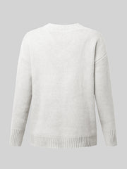 White ribbed trim V-neck knit sweater with long sleeves and ribbed cuffs and hem.