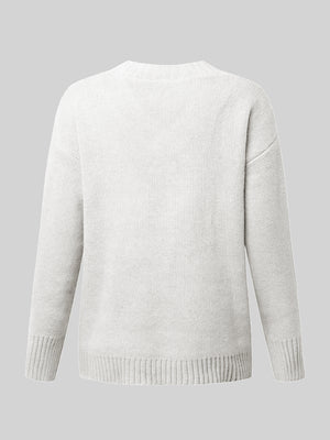 White ribbed trim V-neck knit sweater with long sleeves and ribbed cuffs and hem.