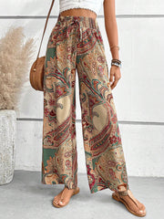 Paisley palazzo trousers with drawstring waist in Multicolor, featuring a boho print and wide leg cut.