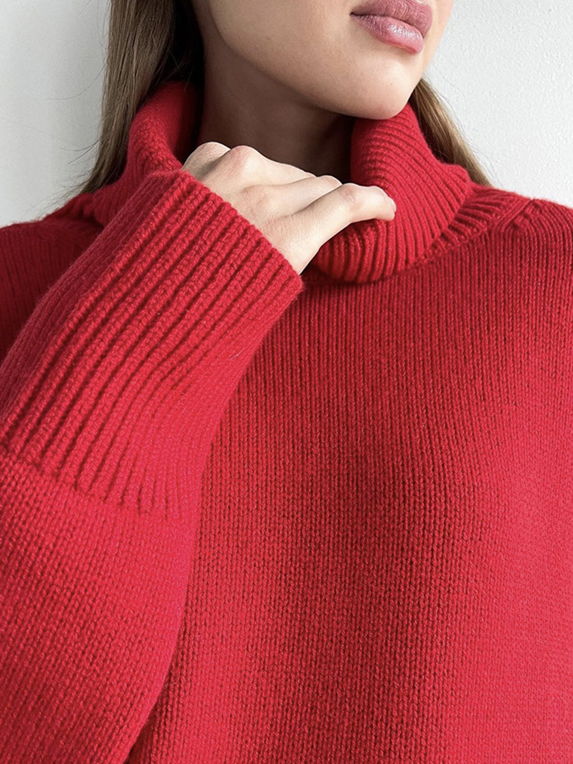 Deep Red acrylic turtleneck sweater with ribbed cuffs and sculptural sleeves.